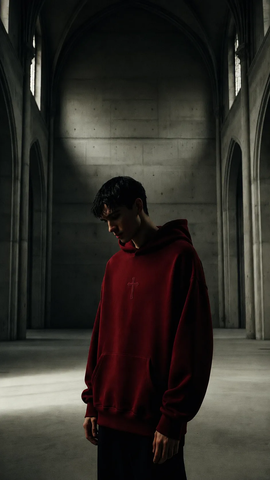 Real Love Apparel - model in oxblood cross hoodie inside cathedral
